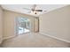 A bedroom with sliding glass doors opens to the pool area at 11291 Countrywood Ct, Spring Hill, FL 34609