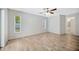 Bedroom featuring wood-look flooring, two windows and en suite bathroom at 11291 Countrywood Ct, Spring Hill, FL 34609