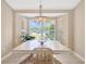 Light and bright dining room with a decorative chandelier and a view of the neighborhood at 11291 Countrywood Ct, Spring Hill, FL 34609
