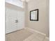 Elegant foyer with double doors, a high ceiling, and a decorative mirror at 11291 Countrywood Ct, Spring Hill, FL 34609