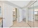 Hallway featuring bathroom entrance with granite vanity and mirrored closet at 11291 Countrywood Ct, Spring Hill, FL 34609