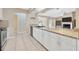 Bright kitchen featuring granite countertops, white cabinets, and a modern faucet at 11291 Countrywood Ct, Spring Hill, FL 34609