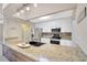 Modern kitchen featuring stainless steel appliances and light granite countertops at 11291 Countrywood Ct, Spring Hill, FL 34609