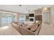 Comfortable living room with a fireplace, TV, and sliding glass doors to the pool area at 11291 Countrywood Ct, Spring Hill, FL 34609