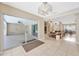 Open-concept living space with tile floors, living room, and sunroom with pool view at 11291 Countrywood Ct, Spring Hill, FL 34609