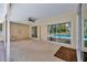 View of a covered patio with a ceiling fan and access to the pool through sliding glass doors at 11291 Countrywood Ct, Spring Hill, FL 34609