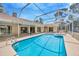 Beautiful screened-in pool area featuring a large pool, spa, and patio space at 11291 Countrywood Ct, Spring Hill, FL 34609