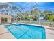 A sparkling pool is enclosed in a screened enclosure at 11291 Countrywood Ct, Spring Hill, FL 34609