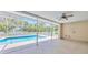 Screened-in patio with a view of the sparkling pool at 11291 Countrywood Ct, Spring Hill, FL 34609