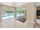 Sunroom with sliding glass doors opening to screened-in lanai and pool at 11291 Countrywood Ct, Spring Hill, FL 34609