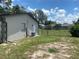 Backyard features include mature trees and a partially fenced yard at 11392 Beechdale Ave, Spring Hill, FL 34608