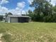 Expansive backyard features a screened-in porch and mature trees providing ample shade at 11392 Beechdale Ave, Spring Hill, FL 34608