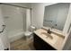 A well-maintained bathroom with vanity, mirror, and shower at 11392 Beechdale Ave, Spring Hill, FL 34608