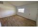 Cozy bedroom features a neutral color scheme, natural light, and stylish wood-look floors at 11392 Beechdale Ave, Spring Hill, FL 34608