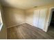 Comfortable bedroom with neutral walls, closet space, and modern wood-look flooring at 11392 Beechdale Ave, Spring Hill, FL 34608