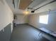 A clean, organized garage space with painted walls and floor, and ample lighting at 11392 Beechdale Ave, Spring Hill, FL 34608