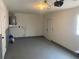 Well-maintained garage featuring an epoxy floor, clean organization, and a functional water heater setup at 11392 Beechdale Ave, Spring Hill, FL 34608