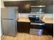 Close up on stainless steel appliances, dark wood cabinets and light counter tops at 11392 Beechdale Ave, Spring Hill, FL 34608