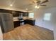 Bright kitchen featuring stainless steel appliances, ample counter space, and wood-look flooring at 11392 Beechdale Ave, Spring Hill, FL 34608