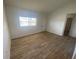 Bright and airy living room with neutral walls and modern wood-look flooring at 11392 Beechdale Ave, Spring Hill, FL 34608