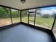 Enclosed screen porch with epoxy floor overlooks a spacious, fenced backyard, perfect for outdoor living at 11392 Beechdale Ave, Spring Hill, FL 34608