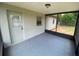 The porch offers an inviting space with an epoxy floor, connecting indoor comfort with a view of the lush outdoors at 11392 Beechdale Ave, Spring Hill, FL 34608