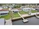 Aerial view showcasing a home with waterfront access, dock, screened porch, and charming backyard at 12637 2Nd Isle, Hudson, FL 34667