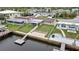 Aerial view featuring waterfront home with dock, screened-in porch, and lovely outdoor area at 12637 2Nd Isle, Hudson, FL 34667