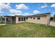 View of the side and rear exterior of the home and screened-in lanai at 12637 2Nd Isle, Hudson, FL 34667