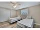 Bedroom with wood floors, two twin beds, closet, and a ceiling fan at 12637 2Nd Isle, Hudson, FL 34667