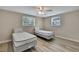 Bedroom featuring wood floors, ceiling fan, and natural light from two windows at 12637 2Nd Isle, Hudson, FL 34667