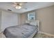 Neutral bedroom with tile floors, a ceiling fan, a closet, and a window letting in natural light at 12637 2Nd Isle, Hudson, FL 34667