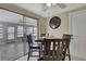 Dining area with tile floors, glass doors to a sunroom, and a decorative clock on the wall at 12637 2Nd Isle, Hudson, FL 34667