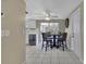 Cozy dining area with tile flooring, table with four chairs, and sliding glass doors at 12637 2Nd Isle, Hudson, FL 34667
