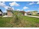 Single-story home with a brick facade, turquoise shutters, and a well-manicured lawn at 12637 2Nd Isle, Hudson, FL 34667