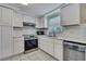 Well-lit kitchen featuring white cabinets, stainless steel appliances and subway tile backsplash at 12637 2Nd Isle, Hudson, FL 34667