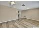 Spacious living room featuring stylish wood flooring and neutral wall tones at 12637 2Nd Isle, Hudson, FL 34667