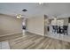 Open-concept living area featuring modern flooring, neutral paint, and seamless flow to the dining area and kitchen at 12637 2Nd Isle, Hudson, FL 34667