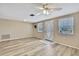 Inviting living room with wood flooring, ceiling fan, and natural light from the windows at 12637 2Nd Isle, Hudson, FL 34667