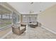 Bright sunroom with tile floors, multiple windows, ceiling fans, and comfortable wicker furniture at 12637 2Nd Isle, Hudson, FL 34667