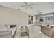 Bright sunroom with tile floors, multiple windows, ceiling fans, and comfortable wicker furniture at 12637 2Nd Isle, Hudson, FL 34667