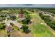 Aerial view of home backing onto the golf course with mature tree coverage at 13349 Niti Dr, Hudson, FL 34669