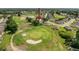 Aerial view of home situated on golf course, surrounded by lush greenery and mature trees at 13349 Niti Dr, Hudson, FL 34669