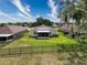 Large backyard features manicured lawn, screened-in patio, and secure fencing for privacy and outdoor enjoyment at 13349 Niti Dr, Hudson, FL 34669