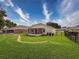 Picture of a well-maintained, fenced backyard with lush lawn and screened patio of a single-Gathering home at 13349 Niti Dr, Hudson, FL 34669