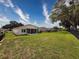Spacious backyard featuring a well-maintained lawn, fenced perimeter, and covered patio, creating an inviting outdoor space at 13349 Niti Dr, Hudson, FL 34669