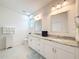 Elegant bathroom features double vanity sinks, granite counters, and ample storage at 13349 Niti Dr, Hudson, FL 34669