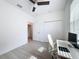 Bright bedroom with wood floors, ceiling fan, closet, and work desk with chair at 13349 Niti Dr, Hudson, FL 34669