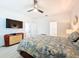Bright main bedroom with a ceiling fan, wood flooring, and ensuite bathroom access at 13349 Niti Dr, Hudson, FL 34669