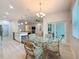 Bright dining area featuring sliding door and a glass top table with four chairs at 13349 Niti Dr, Hudson, FL 34669